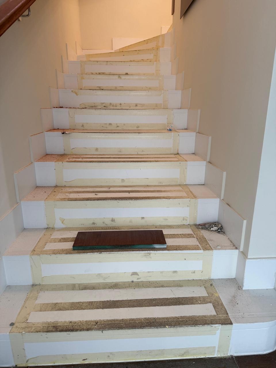 Same staircase before renovation, still under protective wrap.