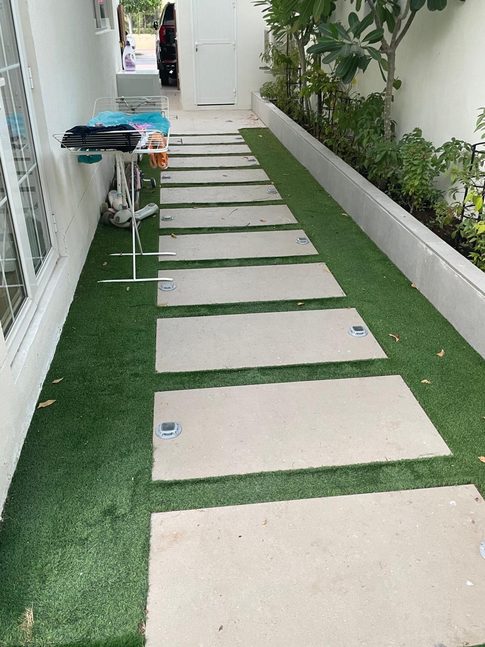 Same side passage before renovation, turf and concrete pavers.