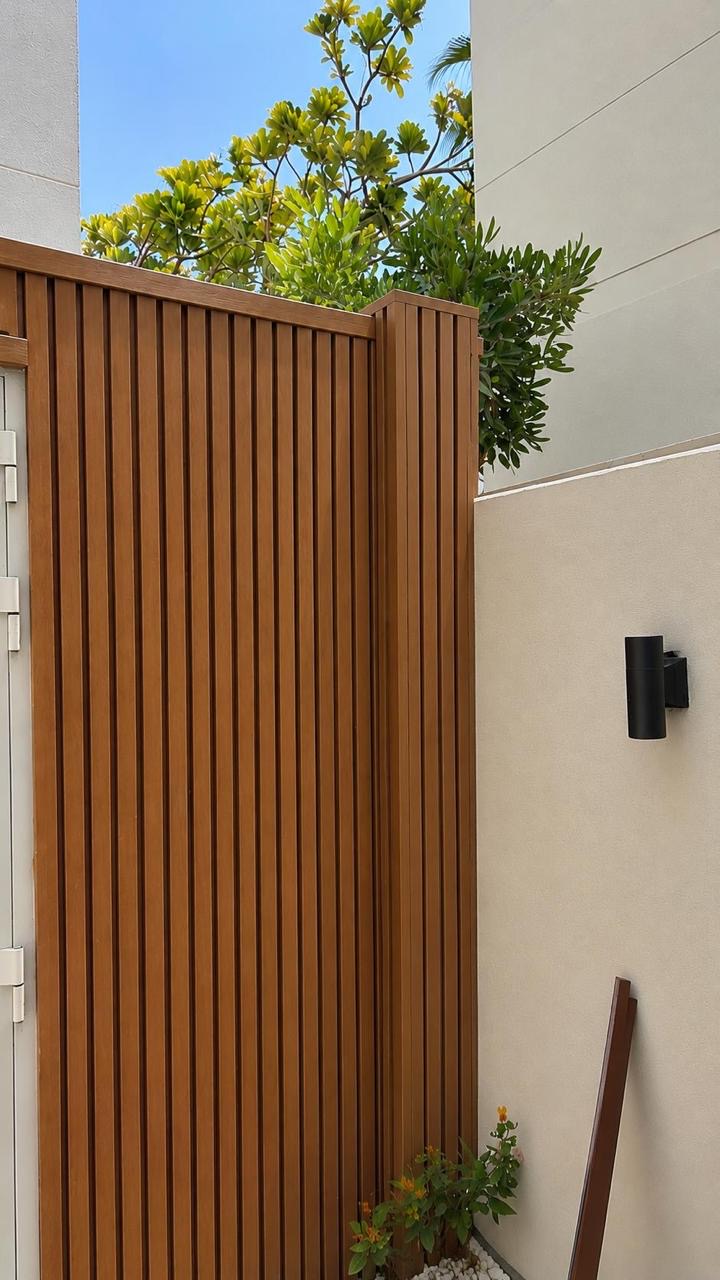 Timber slat gate and screening wall.